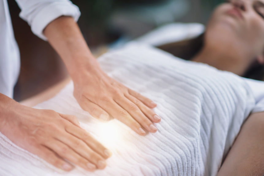 Reiki practitioner performing healing on a client for physical pain relief — Earth Aya Energy Healesville