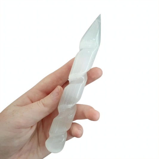 A hand-carved Pointed Spiral Selenite Wand, perfect for energy cleansing, meditation, and aura purification.