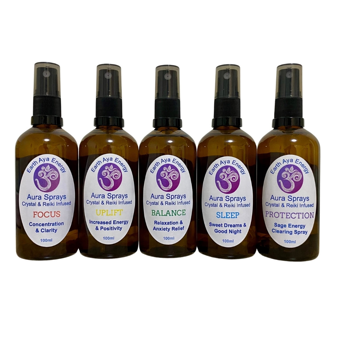 Set of five Aura Sprays arranged in a row, each with a unique label and crystal-infused blend.