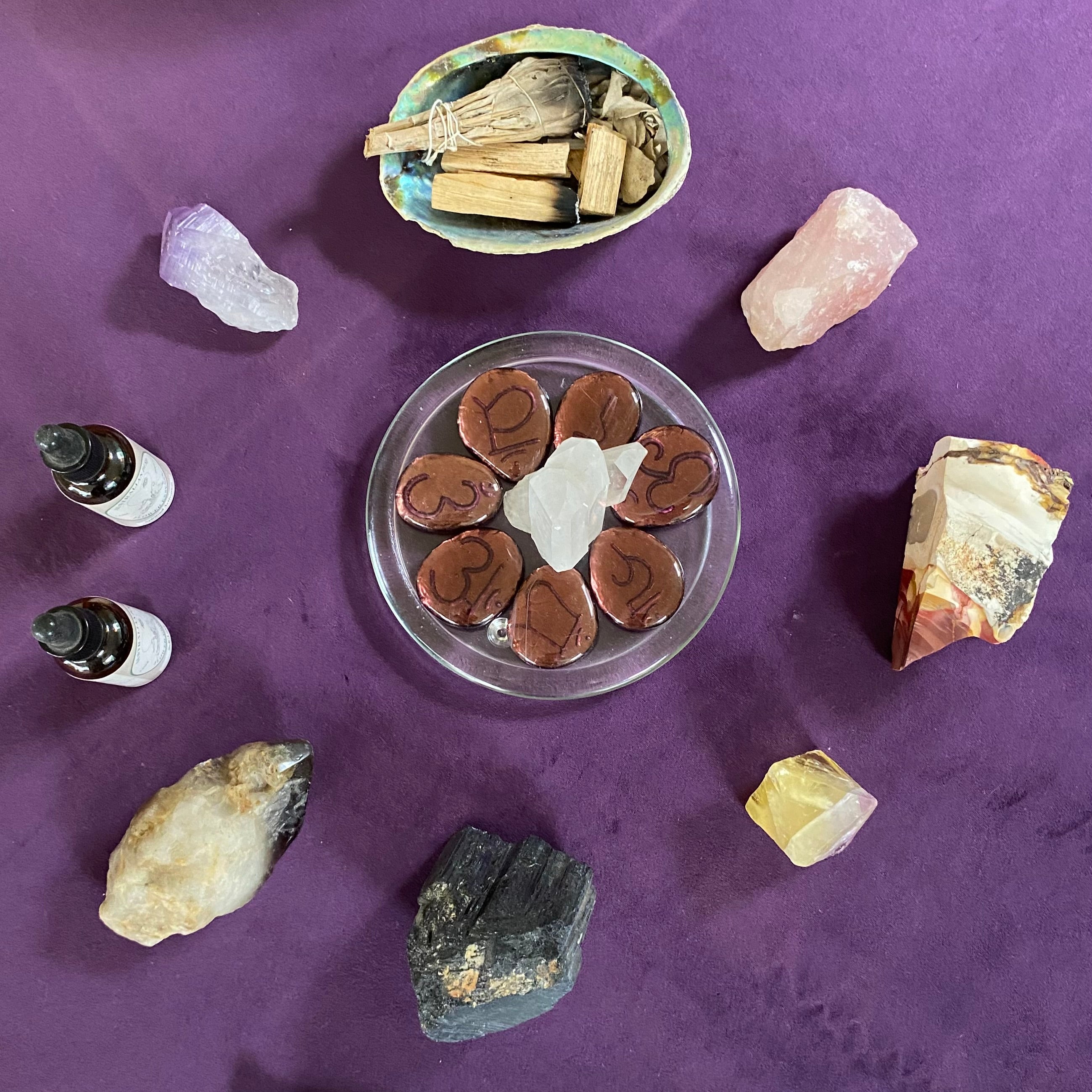 Crystal altar with chakra stones, sage, palo santo, and flower essences set up for a Reiki Share class at Earth Aya Energy, Healesville